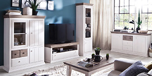 Eine weiße Wohnwand mit Holzdetails steht in einem blauen Wohnzimmer.